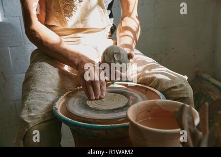 partial view of professional potter working with clay at workshop Stock Photo
