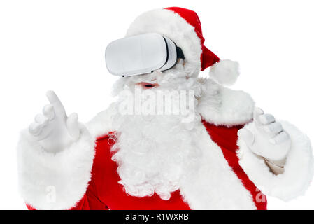 bearded santa claus gesturing and using virtual reality headset isolated on white Stock Photo