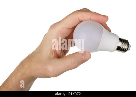 An elderly man holds in his hand a new LED  light bulb to install it in the lamp. Isolated on white studio concept Stock Photo