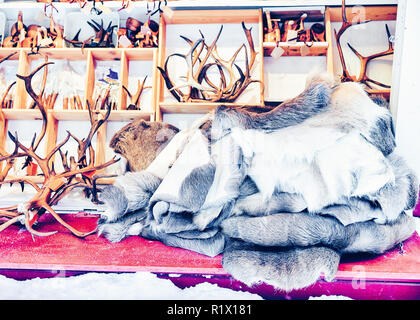 Winter Saami Souvenirs such as reindeer fur and horns on Finnish Christmas Market in Finland in Lapland in winter. Stock Photo