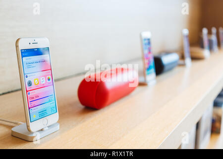 BANGKOK, THAILAND - November 11, 2018:   New iPhone 8 and iPhone 8 Plus charging in docking station and portable speaker goes on sale in Apple Store a Stock Photo