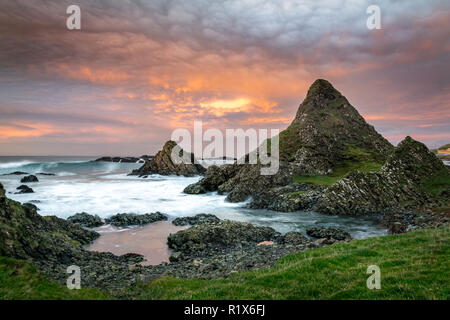 This is a picture of the rocky coast at Ballintoy on the Antrim Coast in Northern Ireland.  It was taken at sunset Stock Photo