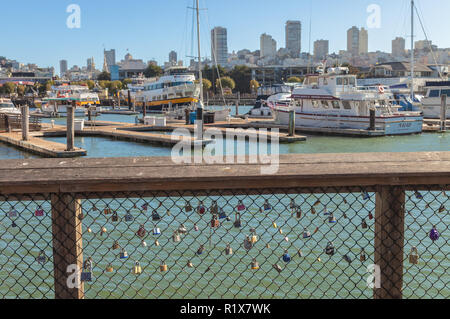 View of the Russian Hill, with docked boats at Marina and the love locks on the fence at Pier 39, San Francisco, California, USA Stock Photo