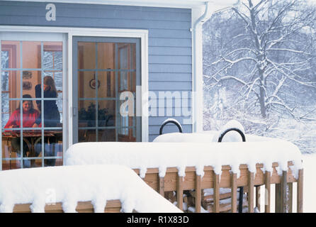 Two young Women inside a Cozy House in a Snowstorm, Northeastern USA Stock Photo