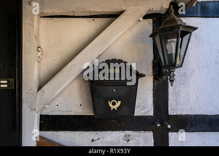 Old lantern and mailbox on the wall. Stock Photo