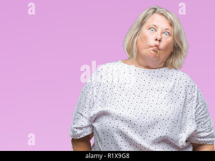 Senior plus size caucasian woman over isolated background making fish face with lips, crazy and comical gesture. Funny expression. Stock Photo