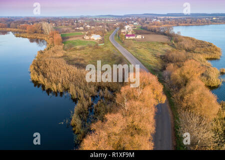 The country road between the lakes in autumn. Aerial view Stock Photo