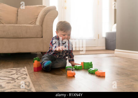 A child boy building from toy blocks at home Stock Photo