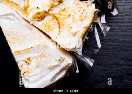 delicious coconut cake on black wooden background Stock Photo