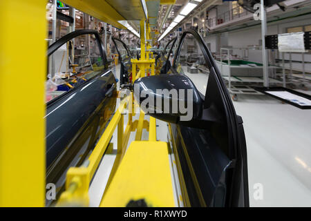 car door on conveyor. Robotic equipment makes Assembly of car. Modern car Assembly at factory Stock Photo