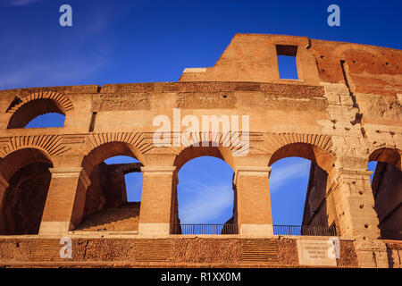 Scenic sunset over the Colosseum. Detail of the marble arches ruins over a blue sky, Rome, Italy Stock Photo