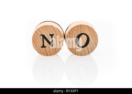 Word No from circular wooden tiles with letters children toy. Concept of approval spelled in children toy letters. Stock Photo