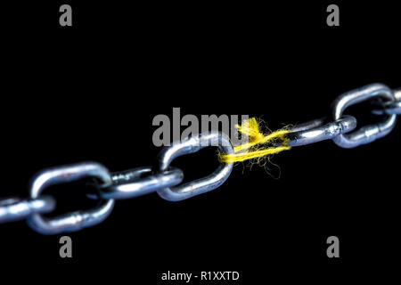 metal chain joint with yarn wire on black background Stock Photo