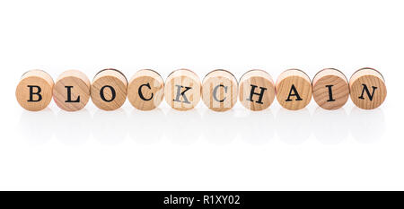 Word Blockchain from circular wooden tiles with letters children toy. Concept of cryptocurrency spelled in children toy letters. Stock Photo