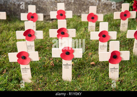 Remembrance crosses and poppies at war memorial for The Great War 1914-1918 - World War I and World War II 1939-1945 in the graveyard of St Mary's Chu Stock Photo