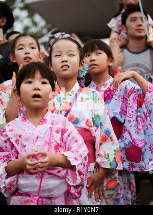 Children in kimono dress dancing to the rhythm of the folk songs in Bon Odori festival. Stock Photo