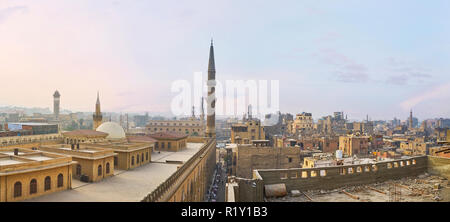 The roofs and minarets of Islamic Cairo, the view on dome of Al-Hussain mosque, the tower of Al Azhar University and old city roofs, occupied with gar Stock Photo