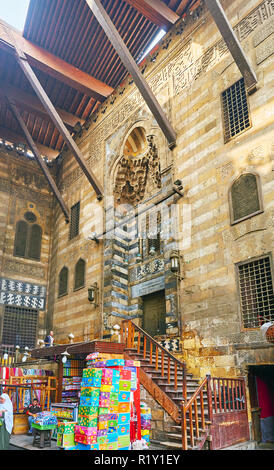 CAIRO, EGYPT - DECEMBER 21, 2017: The market stalls of Souk Khan El-Khalili in gateway of Al-Ghuri Complex, next to the entrance to Mosque-Madrasa, on