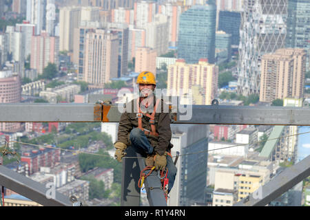(181115) -- BEIJING, Nov. 15, 2018 (Xinhua) -- Worker Chen Jiankang works at a skyscraper construction site in Beijing, capital of China, May 1, 2018. According to a statement issued by the National Bureau of Statistics (NBS), house prices in major Chinese cities remained stable in October as local governments continued tight property regulations. On a month-on-month basis, new house prices in China's four first-tier cities - Beijing, Shanghai, Shenzhen and Guangzhou - were flat with the previous month. New house prices in second-tier cities increased slower than the previous month, while thos Stock Photo