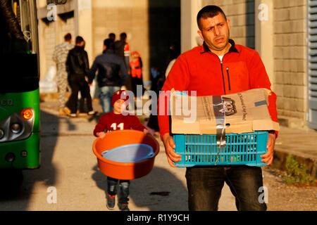 (181115) -- TRIPOLI, Nov. 15, 2018 (Xinhua) -- People carry their belongings waiting to return to Syria in Lebanon's northern city Tripoli, on Nov. 15, 2018. Over 400 Syrian refugees returned on Thursday to their homeland from areas in Lebanon including Bekaa and Aarsal, local media reported. (Xinhua/Khalid)(dtf) Stock Photo