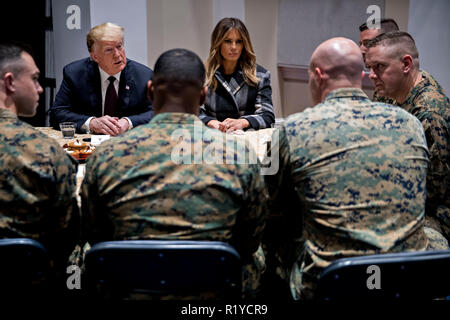 Washington, DC, USA. 15th Nov, 2018. United States President Donald J. Trump, left, and First Lady Melania Trump, center, listen while speaking to Marines at Marine Barracks in Washington, DC, U.S, on Thursday, Nov. 15, 2018. President Trump and the First Lady are meeting with Marines who responded to a building fire at the Arthur Capper Public Housing complex on September 9, 2018. Credit: Andrew Harrer/Pool via CNP | usage worldwide Credit: dpa/Alamy Live News Stock Photo