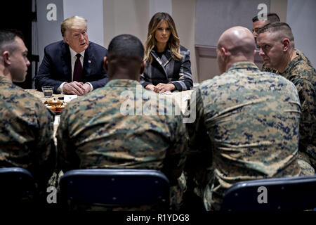 Washington, District of Columbia, USA. 15th Nov, 2018. United States President Donald J. Trump, left, and First Lady Melania Trump, center, listen while speaking to Marines at Marine Barracks in Washington, DC, U.S, on Thursday, Nov. 15, 2018. President Trump and the First Lady are meeting with Marines who responded to a building fire at the Arthur Capper Public Housing complex on September 9, 2018 Credit: Andrew Harrer/CNP/ZUMA Wire/Alamy Live News Stock Photo