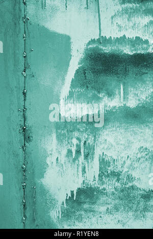 Painted vertical metal sheet surface with rusty abstract stains toned in turquoise as a texture Stock Photo