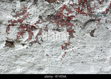 Fragment of old concrete wall with shelled multi-coated surface with lame and different dyes Stock Photo