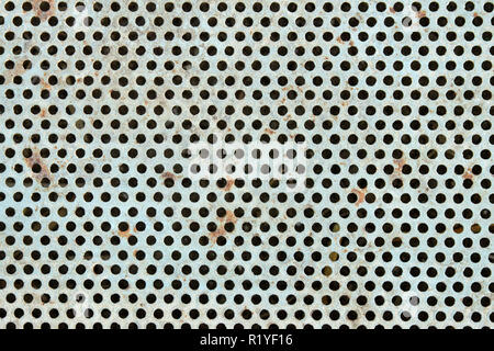 Old metal grate with round holes painted in light blue as a texture Stock Photo