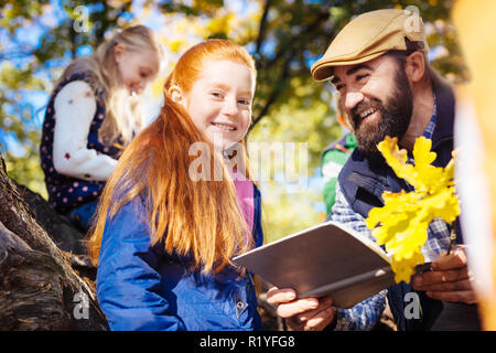 Cheerful red haired girl smiling to you Stock Photo