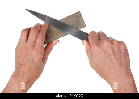 Old elderly cook tries to sharpen steel  long  old  kitchen knife. Isolated on white studio closeup top view Stock Photo