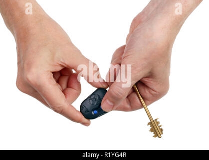 An elderly man presses a button on the remote control of an automatic garage door with a finger. Isolated on white studio  top view shot Stock Photo