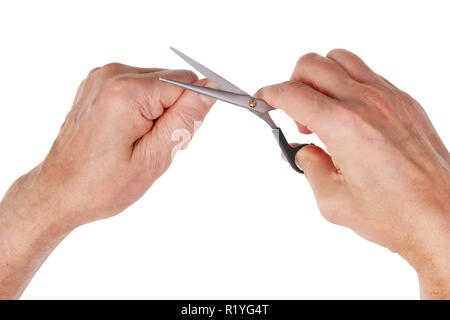 Elderly man cuts old finger nails with steel scissors. Isolated on white studio top view shot Stock Photo