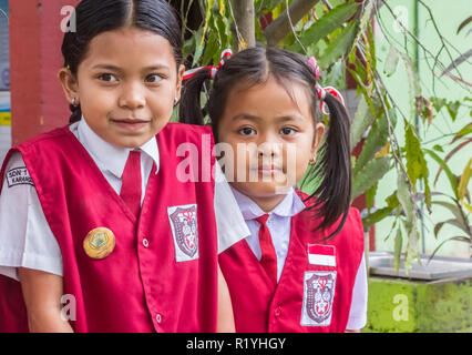 Indonesian schoolgirls in uniform posing in front of their school Stock Photo