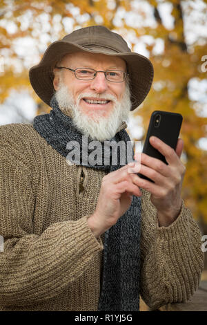 Senior man outdoors using a smartphone Stock Photo