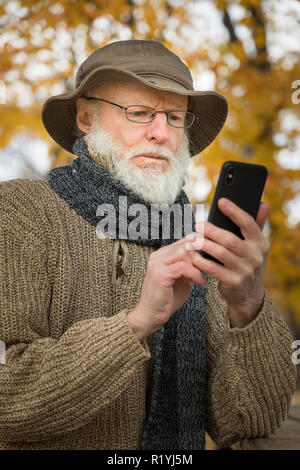 Senior man outdoors using a smartphone Stock Photo