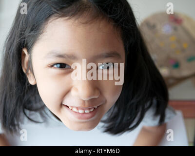 Close up a asian girl looking up a camera Stock Photo