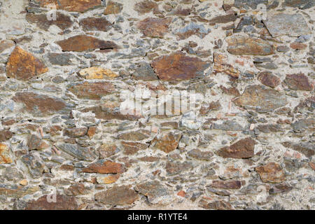 Old 17th century stone wall mixed size and colour stones Stock Photo