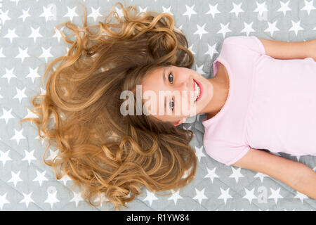 Conditioner mask organic oil keep hair shiny and healthy. Amazing curls tips. Make it curly but natural. Girl long curly hair lay top view. How take care of hair at night. Kid perfect curly hairstyle. Stock Photo