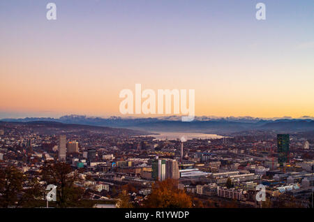Zurich city vista from atop of Hongg in autumn after sunset before blue hour warm tones Stock Photo