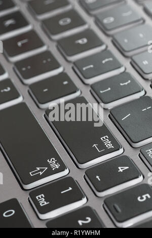 Laptop keyboard macro close up fading enter shift key focused Stock Photo