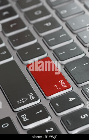 Laptop keyboard macro close up fading enter shift key focused red enter key Stock Photo