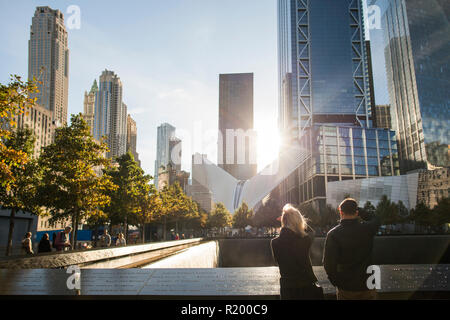 NEW YORK - USA - 28 OCTOBER 2017. A couple is standing in front of the Ground Zero Memorial in Manhattan. Stock Photo