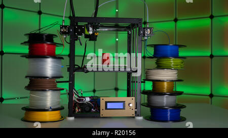 3d printer and plastic filament on color background Stock Photo