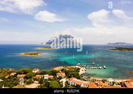 Spectacular aerial view of Tavolara's island bathed by a clear and turquoise sea, porto San Paolo in the foreground. Sardinia, Italy. Stock Photo