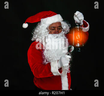 Santa Claus holding lantern for lighting studio shot on black background for family, giving, season, Christmas, holiday, new year, travel, Christian a Stock Photo