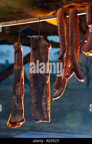 Hecha, Ukraine - JAN 27, 2018: Pork butchers competition. Smoked bacon and sausages hang on the bar. tasty traditional food Stock Photo