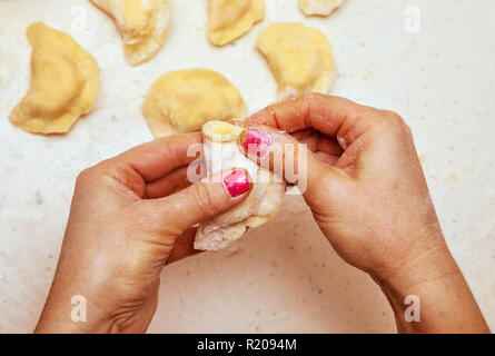 close-up, hands of chef who prepares dumplings from dough Stock Photo