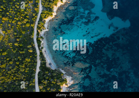 Aerial view of an amazing rocky and green coast bathed by a transparent and turquoise sea. Sardinia, Italy. Stock Photo