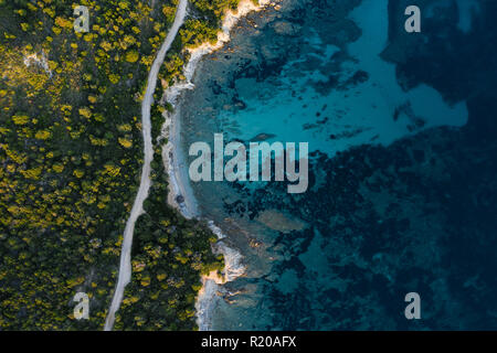 Aerial view of an amazing rocky and green coast bathed by a transparent and turquoise sea. Sardinia, Italy. Stock Photo